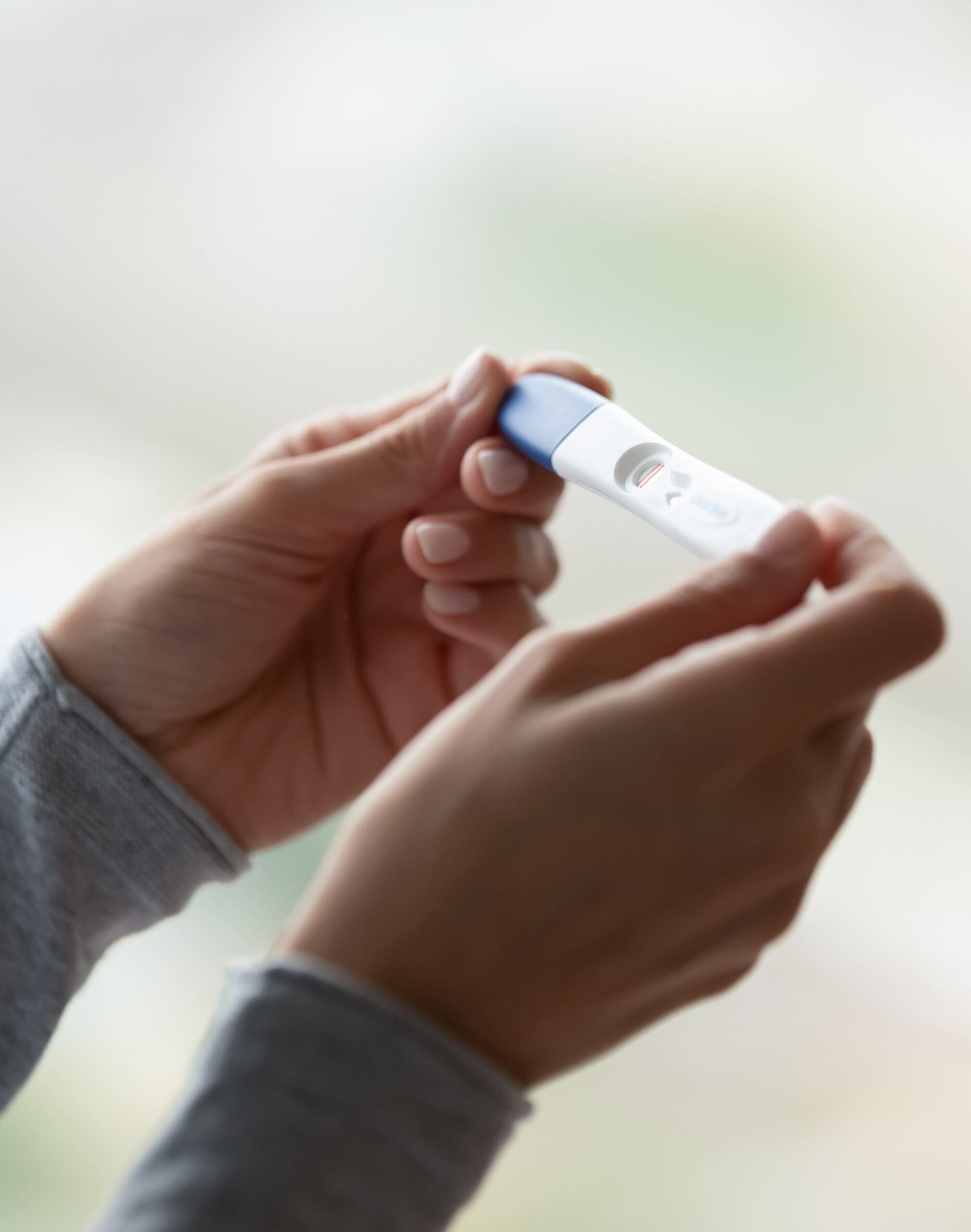 Close Up Of Woman Hands Holding Positive Home Pregnancy Test A woman taking a free and confidential pregnancy test at Choices Resource Center