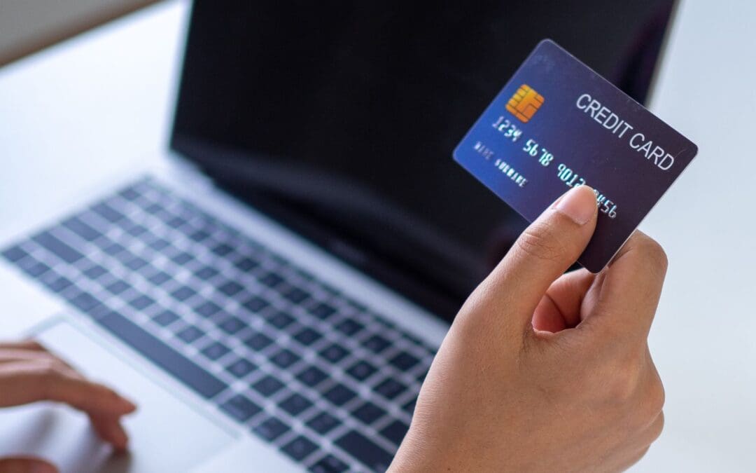 woman holding credit card looking for abortion pill on laptop